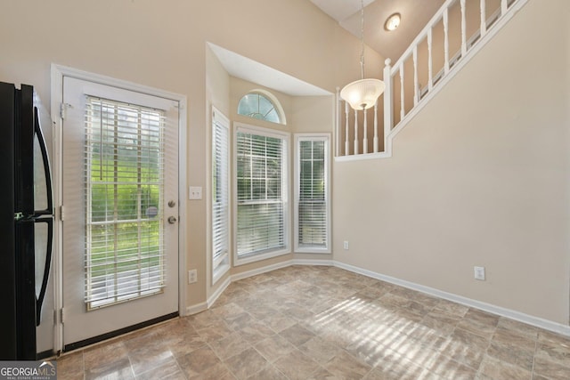 686 Shore Ln, Lithonia, GA 30058 - doorway to outside featuring stone finish floors and a towering ceiling