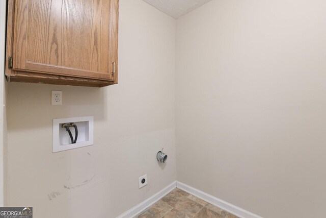 686 Shore Ln, Lithonia, GA 30058 - washroom featuring cabinet space, hookup for a washing machine, and electric dryer hookup