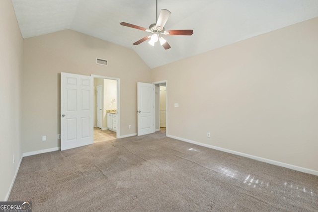 686 Shore Ln, Lithonia, GA 30058 - unfurnished bedroom with lofted ceiling, light colored carpet, ensuite bathroom, and ceiling fan
