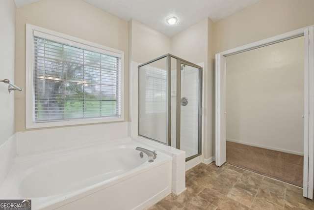 686 Shore Ln, Lithonia, GA 30058 - full bath featuring a garden tub, a shower stall, and a textured ceiling