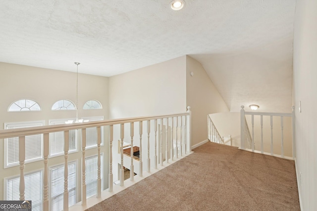 686 Shore Ln, Lithonia, GA 30058 - hall with carpet flooring, an upstairs landing, and a textured ceiling