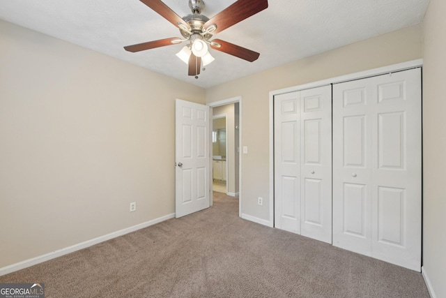 686 Shore Ln, Lithonia, GA 30058 - unfurnished bedroom featuring carpet flooring, a closet, and ceiling fan