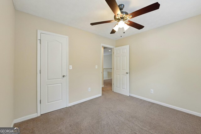 686 Shore Ln, Lithonia, GA 30058 - unfurnished bedroom featuring carpet floors and ceiling fan