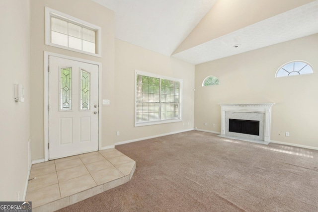 686 Shore Ln, Lithonia, GA 30058 - carpeted foyer featuring plenty of natural light, lofted ceiling, and a premium fireplace