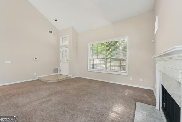 686 Shore Ln, Lithonia, GA 30058 - unfurnished living room featuring carpet floors, a high end fireplace, and high vaulted ceiling