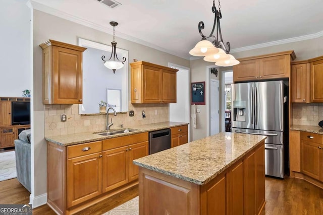 7198 Golfside Dr SE, Covington, GA 30014 - kitchen with stainless steel appliances, dark wood-style flooring, a center island, light stone counters, and ornamental molding