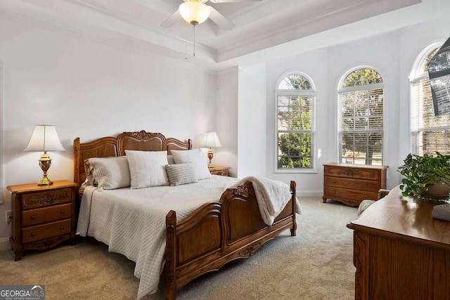 7198 Golfside Dr SE, Covington, GA 30014 - bedroom with light carpet, ornamental molding, a tray ceiling, and a ceiling fan