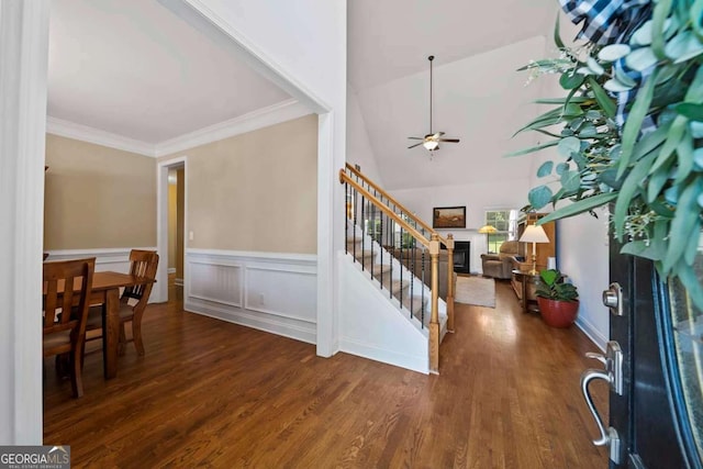 7198 Golfside Dr SE, Covington, GA 30014 - entrance foyer featuring stairway, wood finished floors, a ceiling fan, a fireplace, and wainscoting