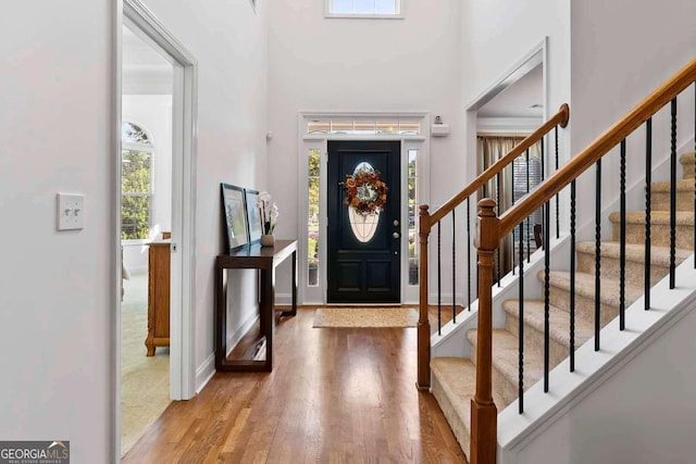 7198 Golfside Dr SE, Covington, GA 30014 - entrance foyer featuring plenty of natural light, wood finished floors, a high ceiling, and stairs