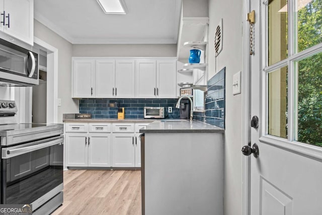 195 Sylvan Rd, Athens, GA 30606 - kitchen with appliances with stainless steel finishes, white cabinetry, crown molding, decorative backsplash, and plenty of natural light