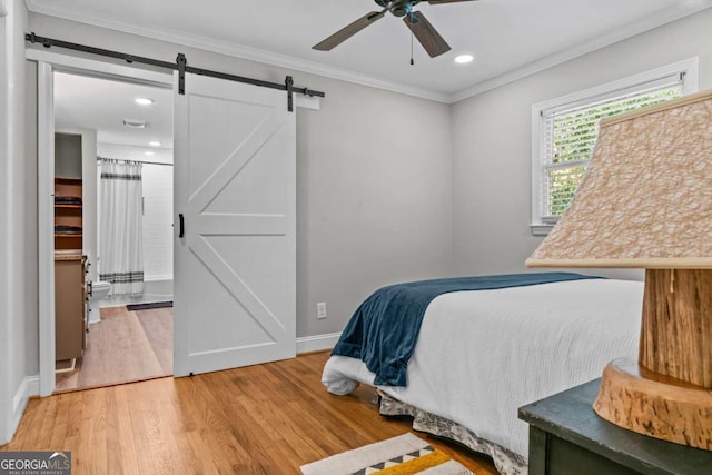 195 Sylvan Rd, Athens, GA 30606 - bedroom featuring light wood-style floors, a barn door, crown molding, recessed lighting, and a ceiling fan
