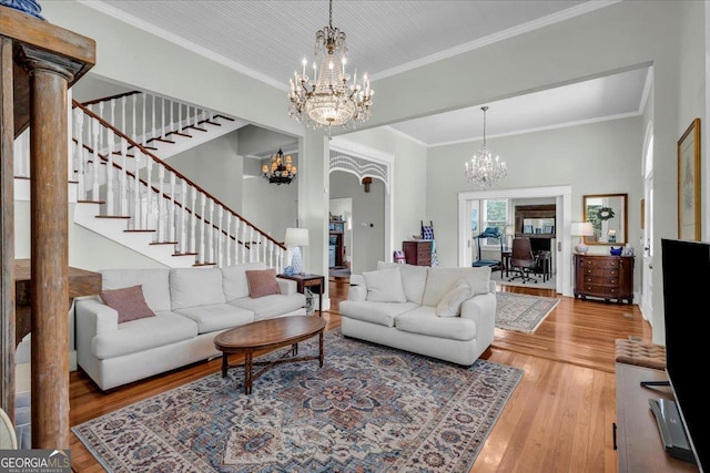 205 Cobb St, Palmetto, GA 30268 - living area with a chandelier, stairway, wood finished floors, and ornamental molding