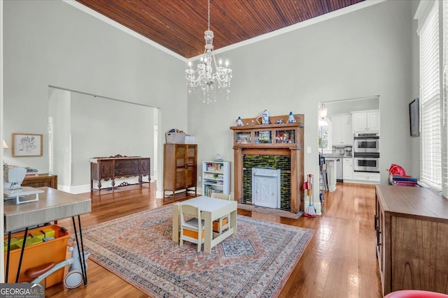 205 Cobb St, Palmetto, GA 30268 - living room with a towering ceiling, wooden ceiling, ornamental molding, a chandelier, and light wood-style flooring