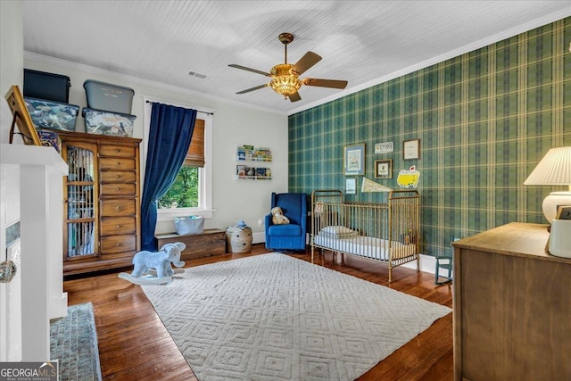 205 Cobb St, Palmetto, GA 30268 - bedroom with ornamental molding, wood finished floors, and wallpapered walls