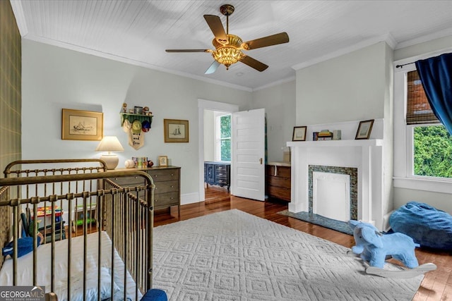 205 Cobb St, Palmetto, GA 30268 - bedroom featuring multiple windows, wood finished floors, crown molding, a fireplace, and ceiling fan