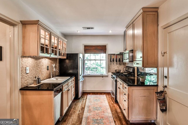 55 Delmont Dr NE Unit C3, Atlanta, GA 30305 - kitchen featuring appliances with stainless steel finishes, dark wood-type flooring, dark countertops, glass insert cabinets, and decorative backsplash