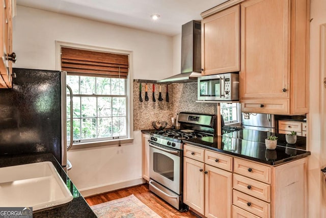 55 Delmont Dr NE Unit C3, Atlanta, GA 30305 - kitchen with stainless steel appliances, light brown cabinets, wall chimney exhaust hood, light wood-style floors, and backsplash
