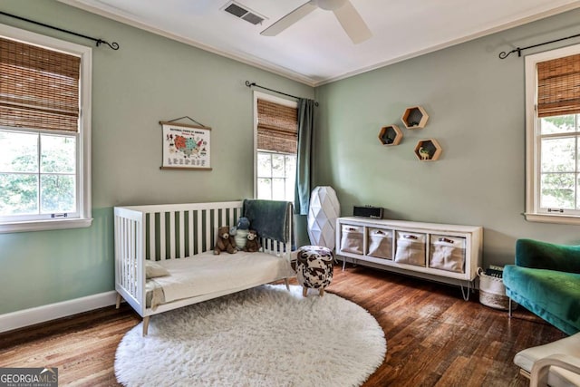55 Delmont Dr NE Unit C3, Atlanta, GA 30305 - bedroom with crown molding, multiple windows, wood finished floors, and a ceiling fan