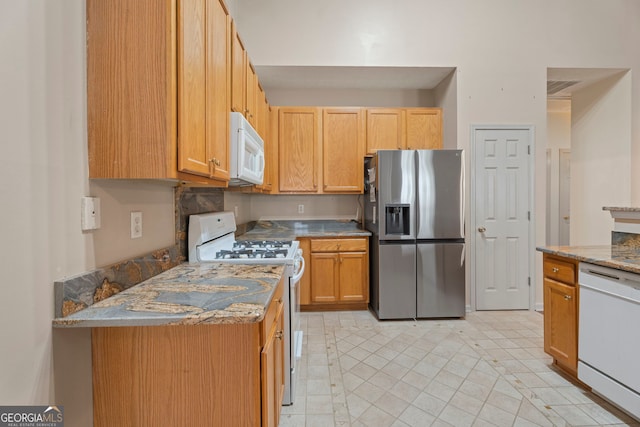 377 Avian Forest Dr, Stockbridge, GA 30281 - kitchen featuring white appliances and light tile patterned floors