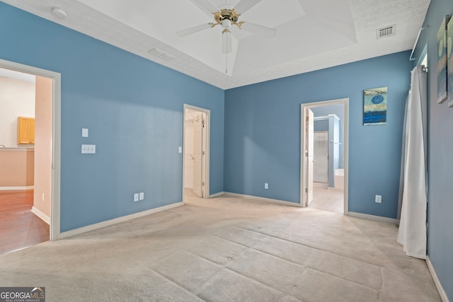 377 Avian Forest Dr, Stockbridge, GA 30281 - unfurnished bedroom featuring connected bathroom, carpet, and a tray ceiling