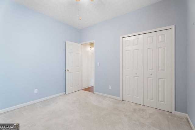 377 Avian Forest Dr, Stockbridge, GA 30281 - unfurnished bedroom with carpet floors, a closet, and a textured ceiling