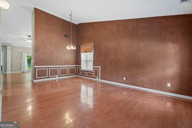377 Avian Forest Dr, Stockbridge, GA 30281 - spare room featuring a chandelier, hardwood / wood-style flooring, a high ceiling, and ceiling fan