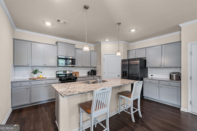 5804 Screech Owl Dr, Flowery Branch, GA 30542 - kitchen with appliances with stainless steel finishes, gray cabinetry, backsplash, dark wood-style flooring, and crown molding
