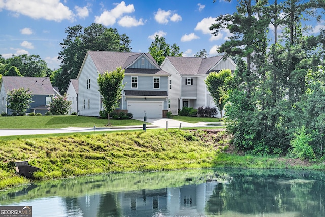 5804 Screech Owl Dr, Flowery Branch, GA 30542 - view of front of home with a garage, concrete driveway, a water view, and a front yard