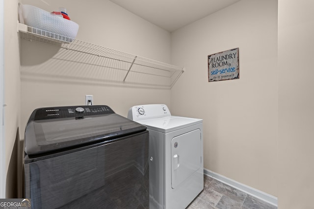 5804 Screech Owl Dr, Flowery Branch, GA 30542 - laundry area featuring separate washer and dryer and light stone finish flooring