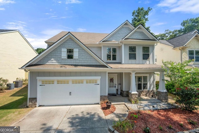 1871 Stoney Chase Dr, Lawrenceville, GA 30044 - craftsman-style home featuring board and batten siding, covered porch, stone siding, concrete driveway, and an attached garage