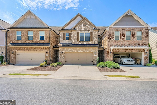 8295 Village Pl, Suwanee, GA 30024 - view of property featuring concrete driveway, a garage, and brick siding