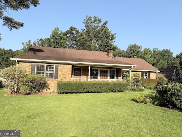 601 Clubland Cir SE, Conyers, GA 30094 - ranch-style house with a front lawn, brick siding, a chimney, and covered porch