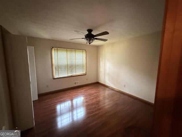 601 Clubland Cir SE, Conyers, GA 30094 - unfurnished room featuring dark wood-type flooring and a ceiling fan