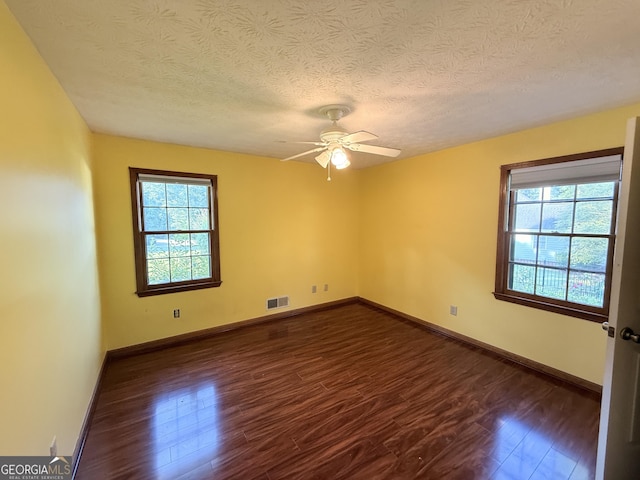 601 Clubland Cir SE, Conyers, GA 30094 - unfurnished room with dark wood-type flooring, healthy amount of natural light, ceiling fan, and a textured ceiling