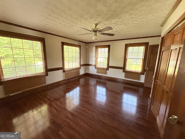601 Clubland Cir SE, Conyers, GA 30094 - empty room featuring dark wood-style floors, ceiling fan, ornamental molding, and a textured ceiling