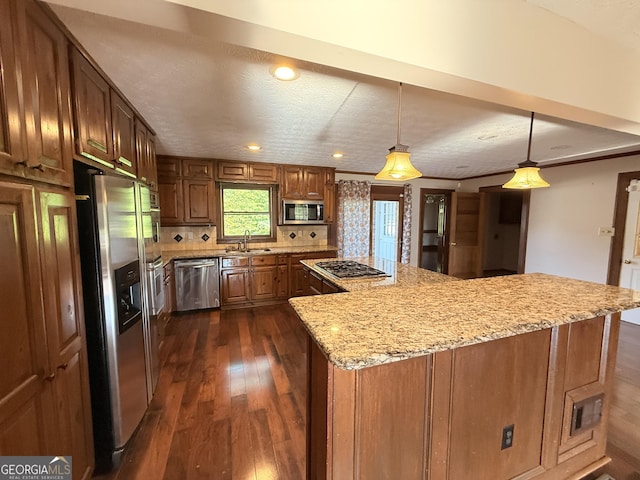 601 Clubland Cir SE, Conyers, GA 30094 - kitchen with stainless steel appliances, light stone counters, dark wood-style flooring, tasteful backsplash, and a kitchen island