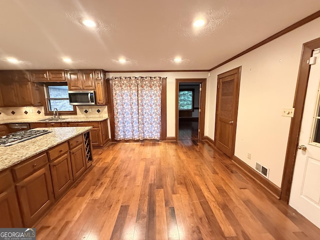 601 Clubland Cir SE, Conyers, GA 30094 - kitchen featuring stainless steel appliances, light wood finished floors, backsplash, recessed lighting, and light stone countertops
