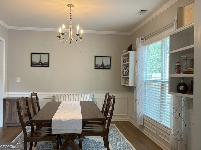 2481 Southhaven Ln, Buford, GA 30519 - dining area with wood finished floors, a chandelier, crown molding, and wainscoting