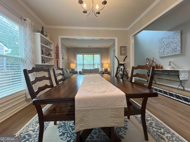 2481 Southhaven Ln, Buford, GA 30519 - dining room featuring wood finished floors, a chandelier, and crown molding
