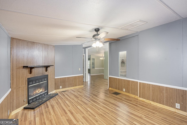 340 Loblolly Rdg, Locust Grove, GA 30248 - unfurnished living room featuring wood finished floors, a fireplace, wood walls, and ceiling fan