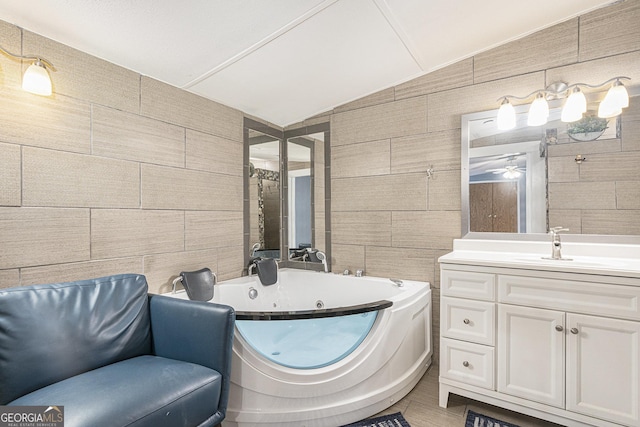 340 Loblolly Rdg, Locust Grove, GA 30248 - bathroom with tile walls, a whirlpool tub, vanity, a ceiling fan, and lofted ceiling