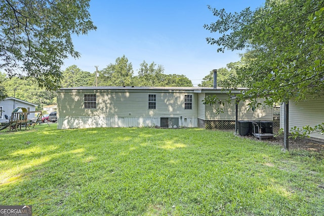 340 Loblolly Rdg, Locust Grove, GA 30248 - rear view of house featuring a lawn