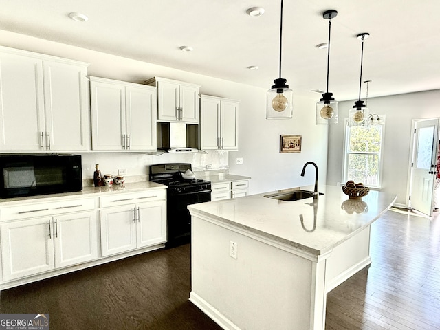 5599 Wheeler Ridge Rd, Auburn, GA 30011 - kitchen with black appliances, range hood, dark wood-style flooring, a center island with sink, and white cabinets