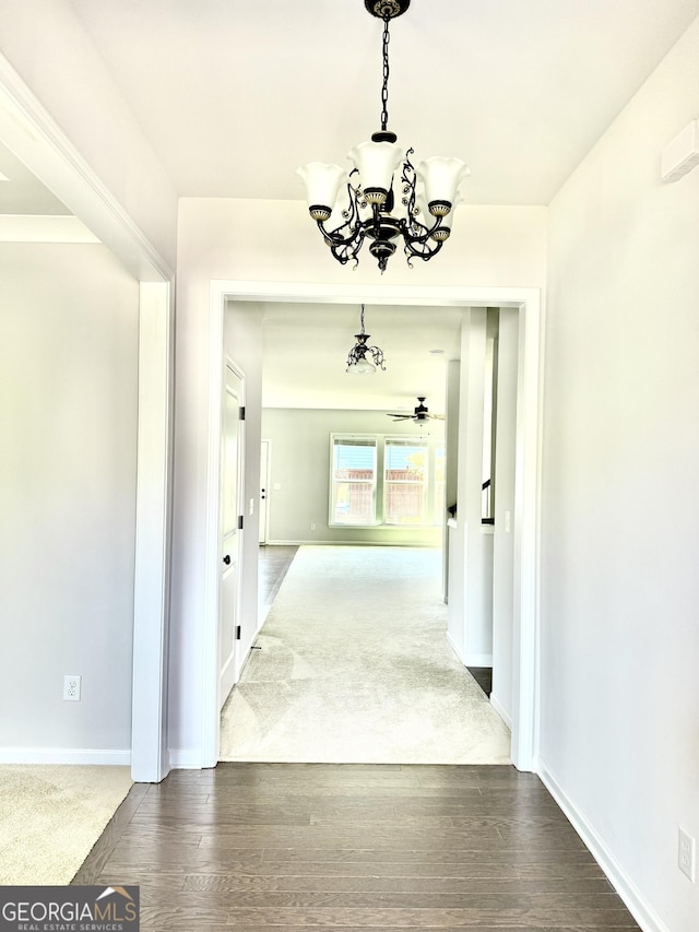 5599 Wheeler Ridge Rd, Auburn, GA 30011 - corridor featuring a chandelier and dark wood-style floors
