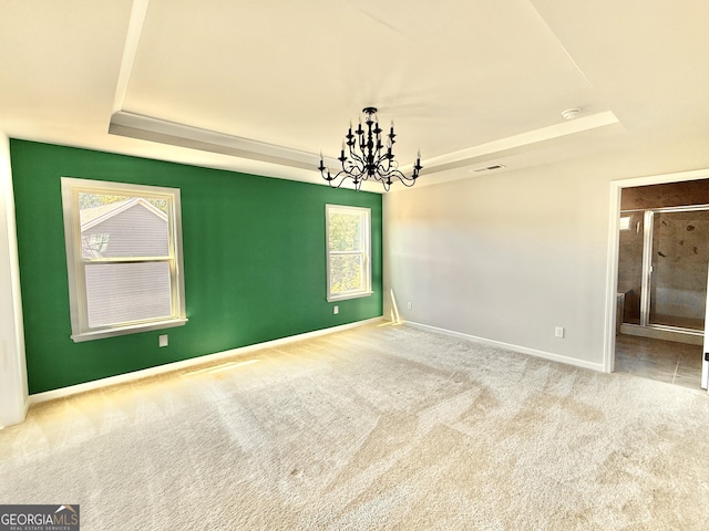 5599 Wheeler Ridge Rd, Auburn, GA 30011 - spare room with a tray ceiling, a chandelier, carpet floors, and plenty of natural light