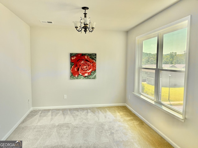 5599 Wheeler Ridge Rd, Auburn, GA 30011 - spare room with a chandelier, carpet floors, and plenty of natural light