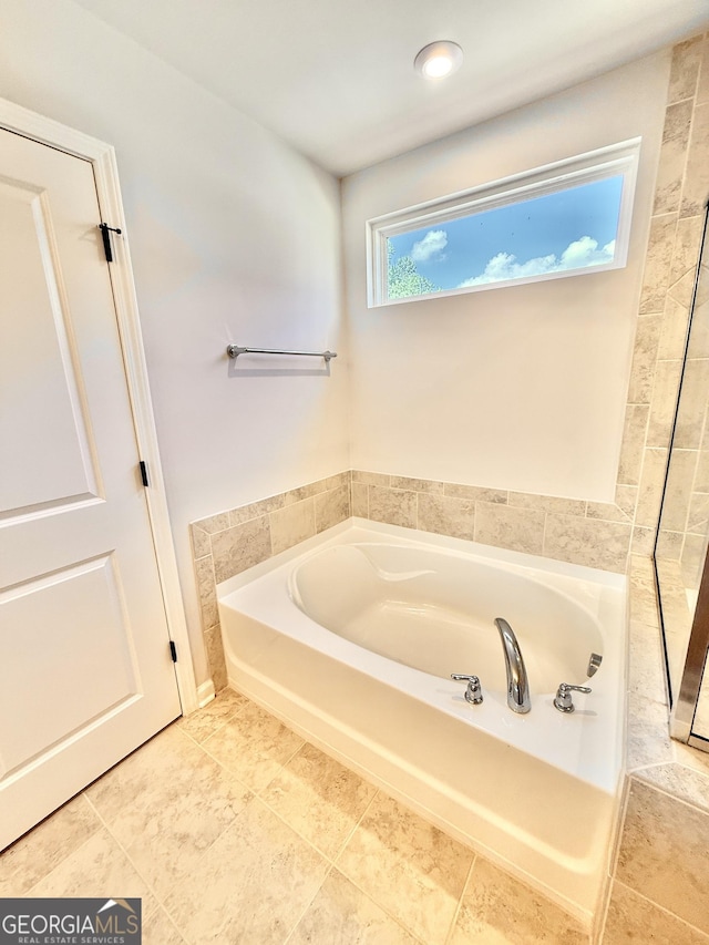 5599 Wheeler Ridge Rd, Auburn, GA 30011 - bathroom featuring a bath and tile patterned floors