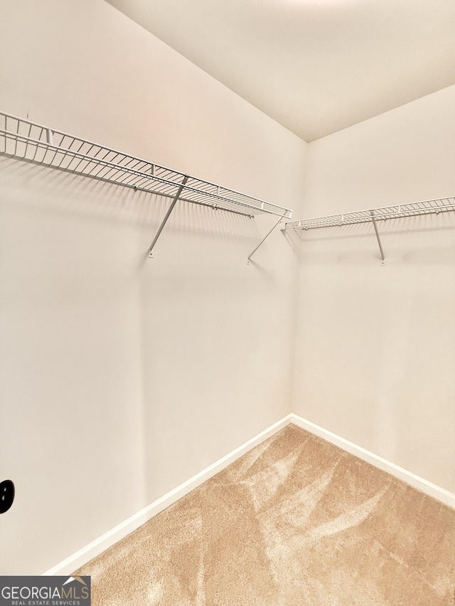 5599 Wheeler Ridge Rd, Auburn, GA 30011 - walk in closet featuring carpet