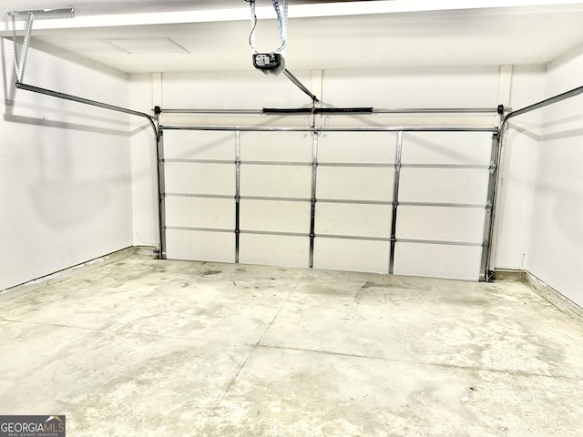 5599 Wheeler Ridge Rd, Auburn, GA 30011 - garage featuring a garage door opener and baseboards