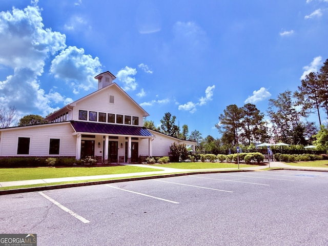 5599 Wheeler Ridge Rd, Auburn, GA 30011 - view of front of home with uncovered parking, a front lawn, and a metal roof
